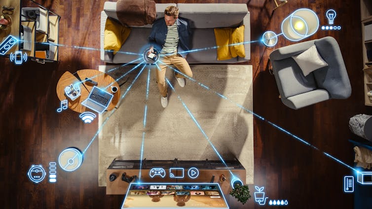 A man sits on a sofa with an overlay demonstrating various smart home connections.