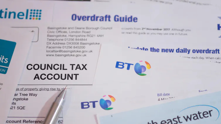 A selection of bills, a credit card and a guide to overdrafts.