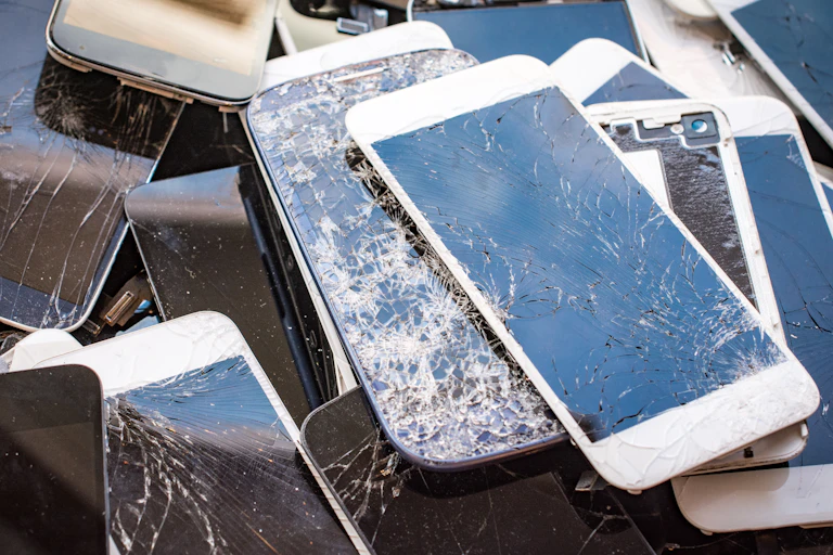A pile of broken phones and tablets.