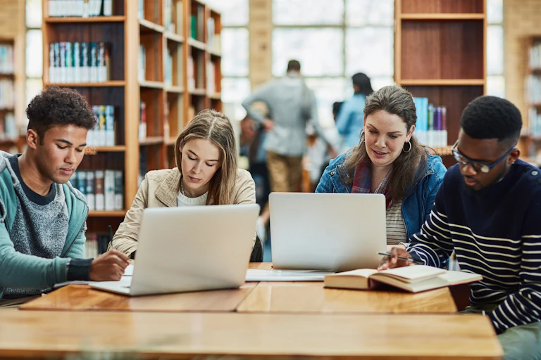 Group of students working in library