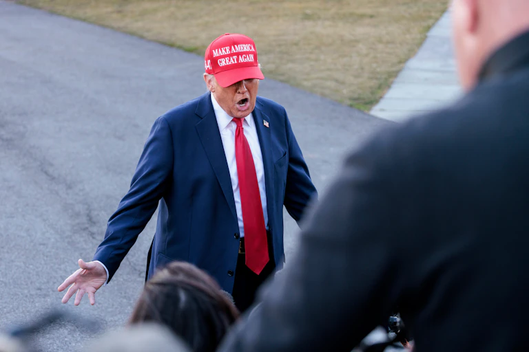 President Donald Trump wearing a cap with the slogan “Make America great again.”