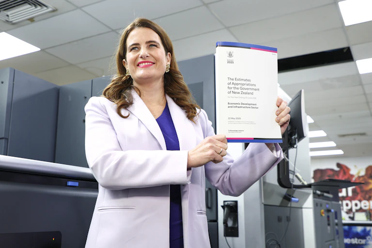 Nicola WIllis holds a copy of her budget.