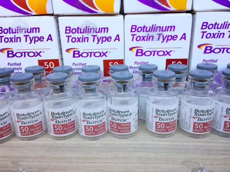 Small vials of clear liquid lined up on a bench top.