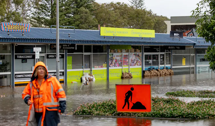 woman in high vis on flooded street