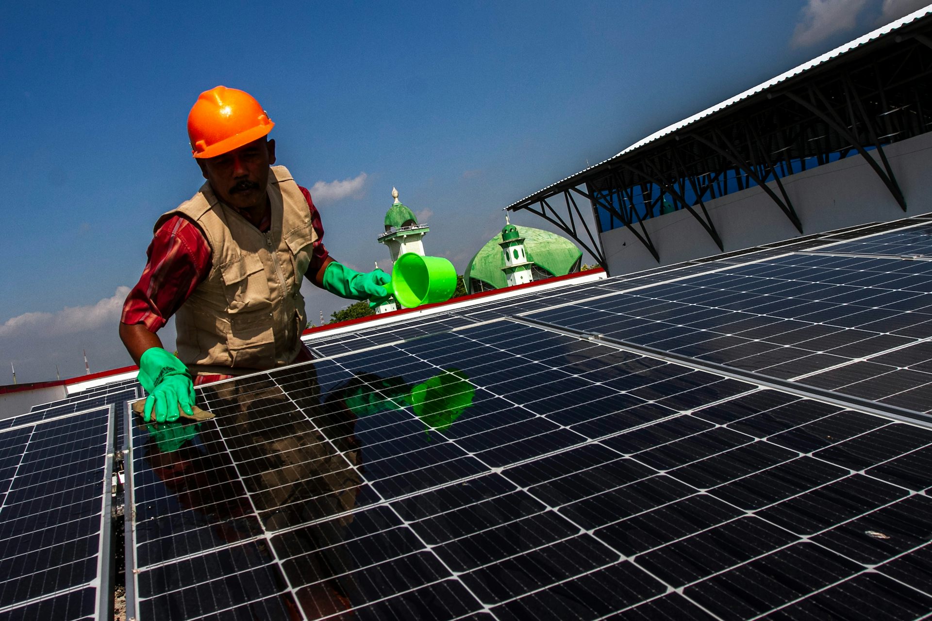 A worker attends a solar panel.