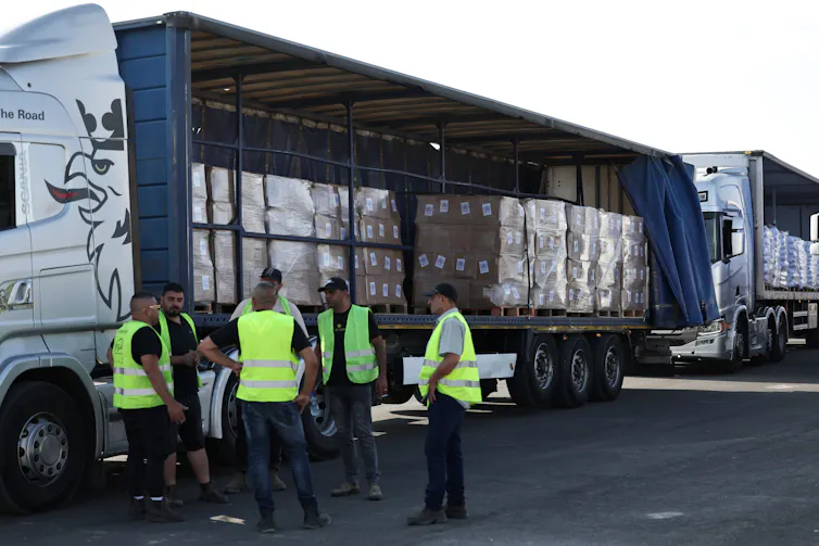 Aid workers with trucks loaded with supplies at a crossing outisde Gaza, May 22.