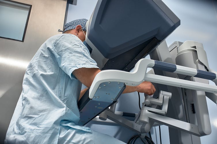 surgeon using robotic surgery equipment