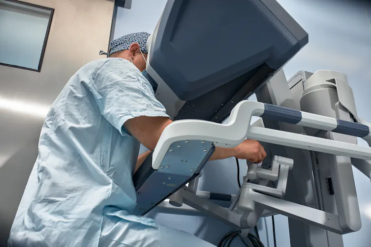 surgeon using robotic surgery equipment