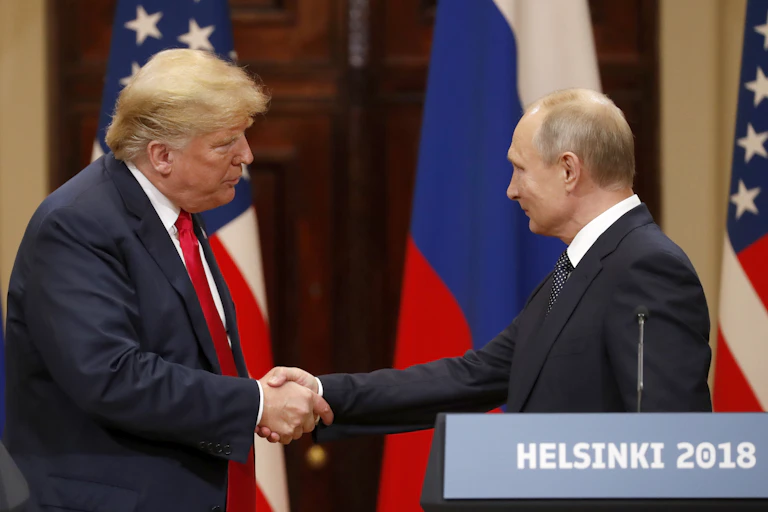US president Donald Trump shaking hands with Russian president Vladimir Putin at a summit meeting in Helsinki in 2018.