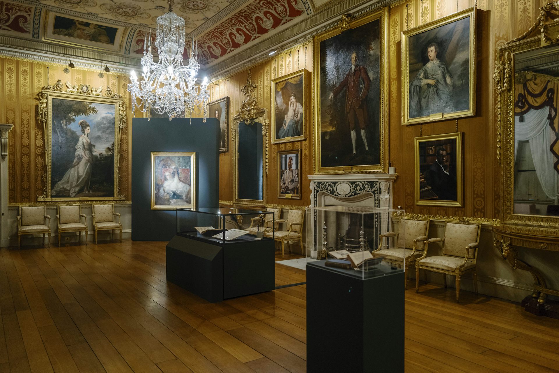 A grand golden room with display cases in the centre