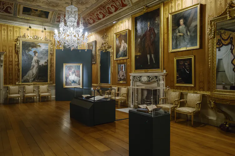 A grand golden room with display cases in the centre