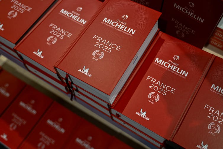 Hardback copies of a red book that says 'Michelin France 2025'