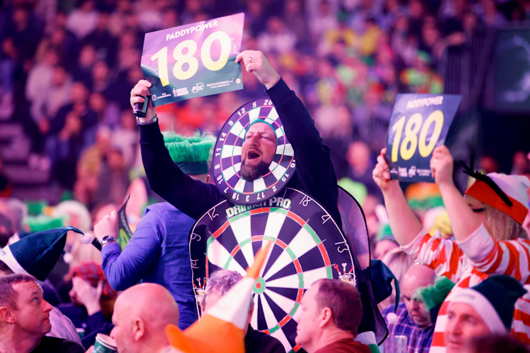 Fans in costume cheer during the 2024 World Darts Championship in London.