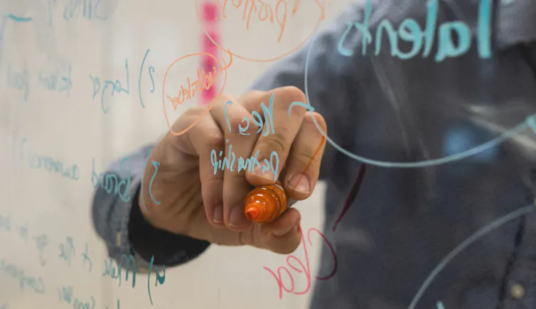 Person writing on a whiteboard