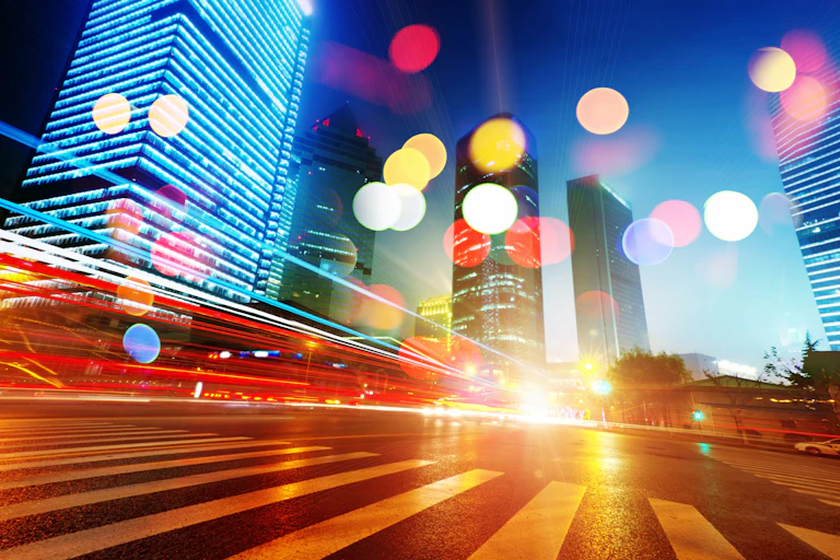 An illustration of a city showing light trails and circles of light.