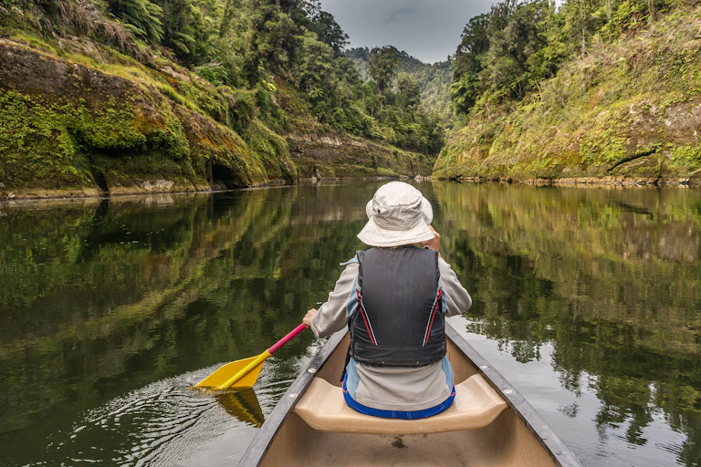 A person kayaking down a river.