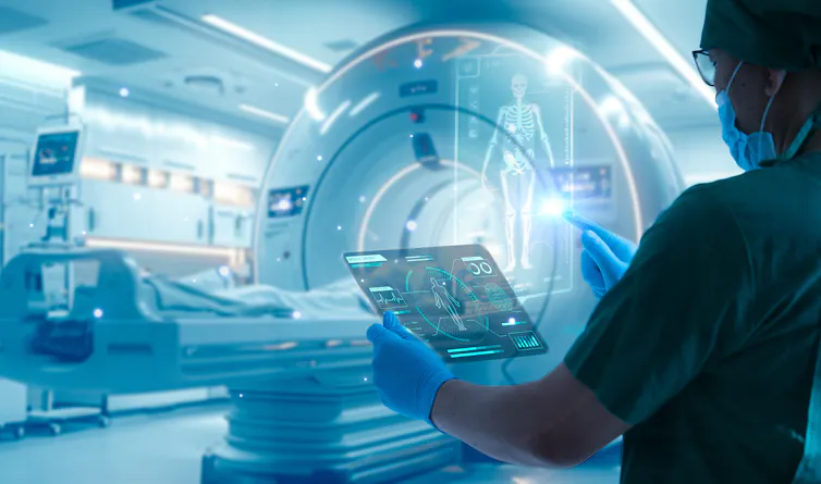 Medic operating high-tech body scanner.