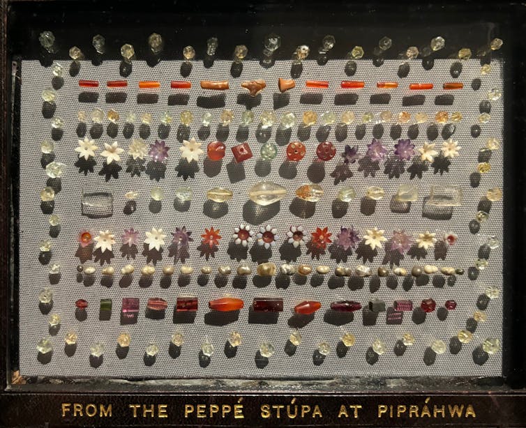 Why public sale of Buddha relics used to be referred to as off and why it issues – knowledgeable in Asian artwork explains 1 A set of gems lined up on a piece of beige material.