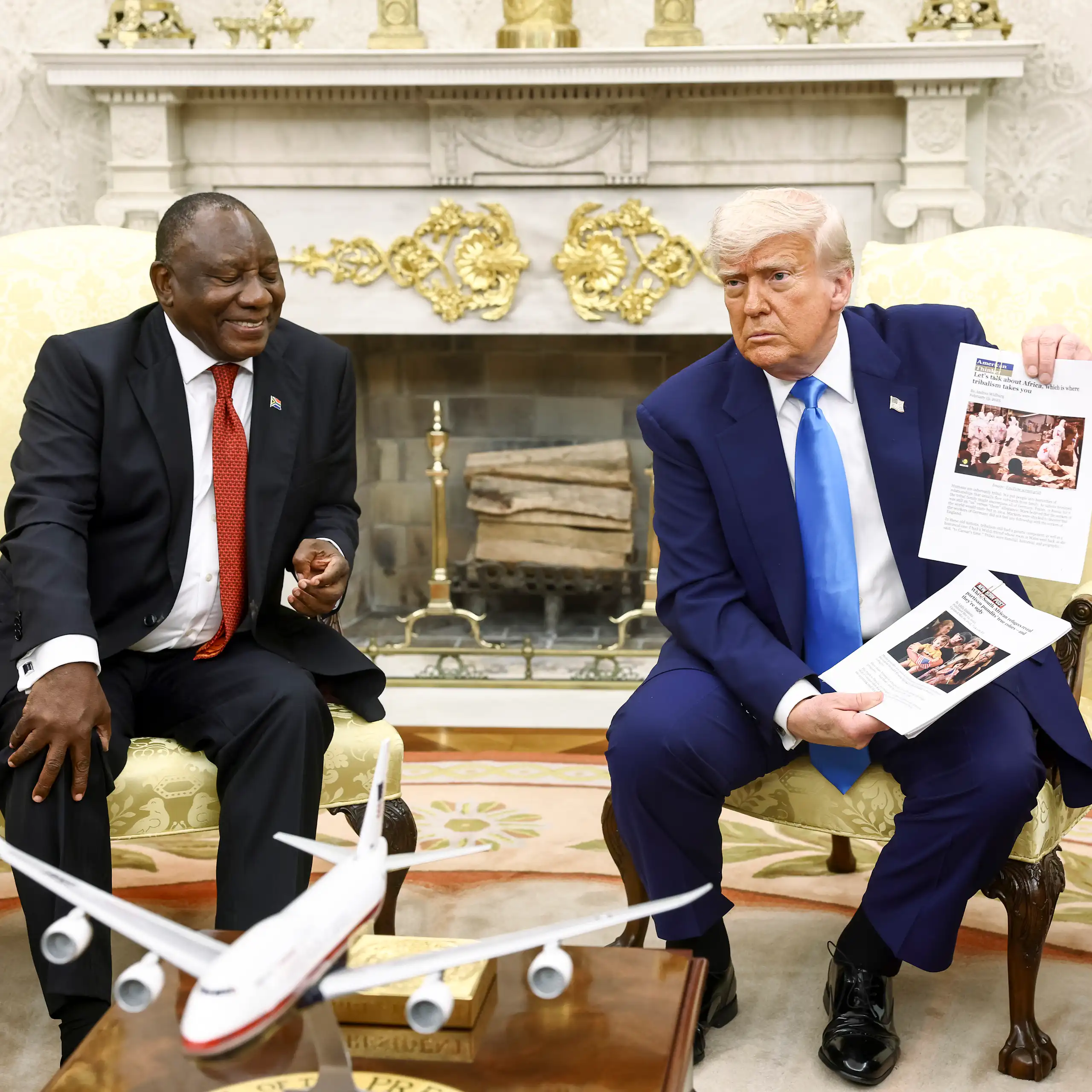 US president Donald Trump shows South African president Cyril Ramaphosa some images on a flip chart