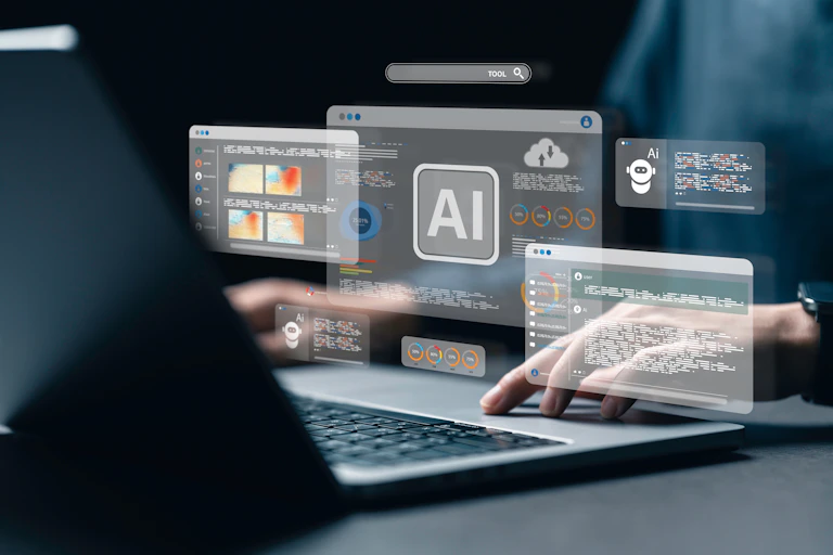 a person sitting at a laptop keyboard with AI related icons floating above their hands