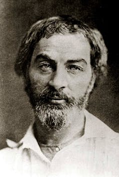 Black-and-white photographic portrait of bearded man.