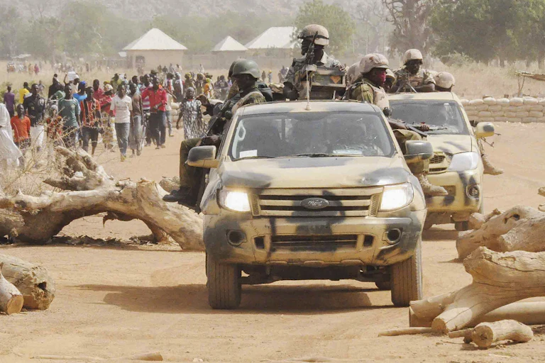 Nigerian soldiers in cars on patrol in Borno state.