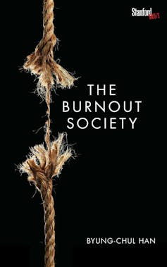 A black background and a vertical rope frayed and severed in the centre