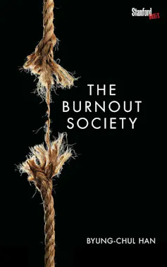 A black background and a vertical rope frayed and severed in the centre