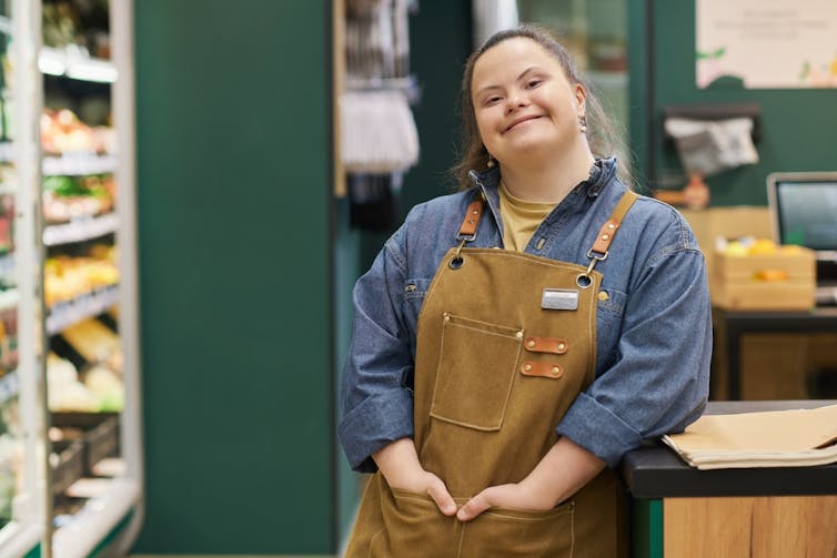 Woman with Down's syndrome wearing apron in workplace