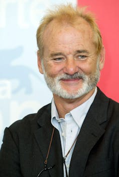 The Phoenician Scheme: a amusing watch even if it’s the similar adventure in a special automobile 1 An older man smiling with his glasses around his neck.