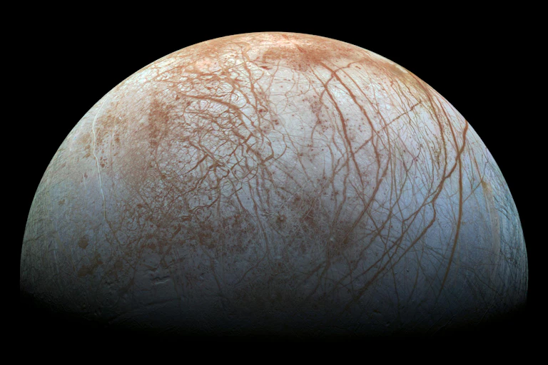 A gray planet with rust-colored lines across its surface.