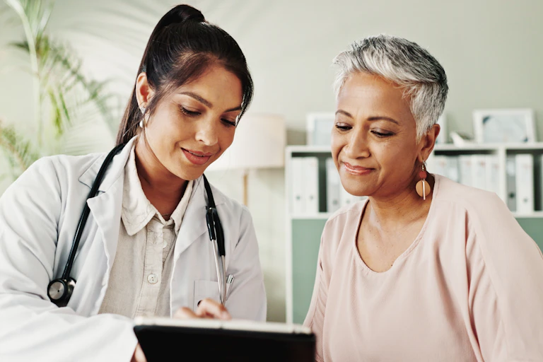A female doctor with a female patient with gray hair