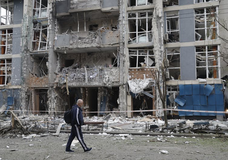 A man walks past a bombed-out building in Ukrainian capital Kyiv.