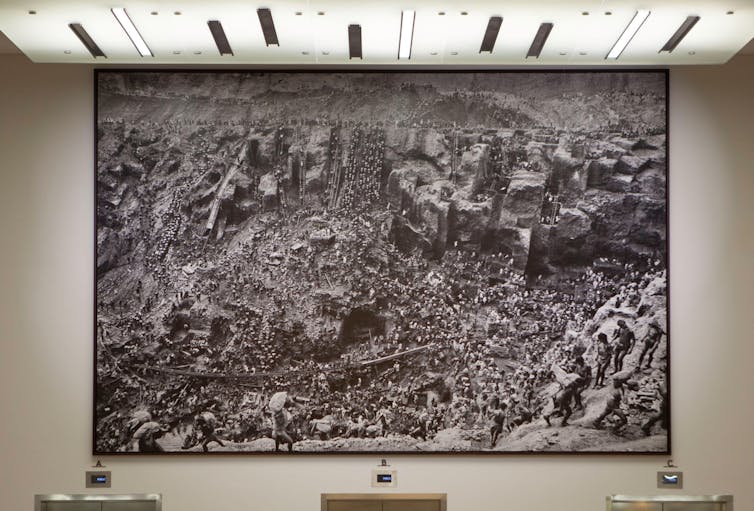 Sebastião Salgado: a photographer of serious humanity 1 A huge black and white photograph of workers in an outside goldmine.