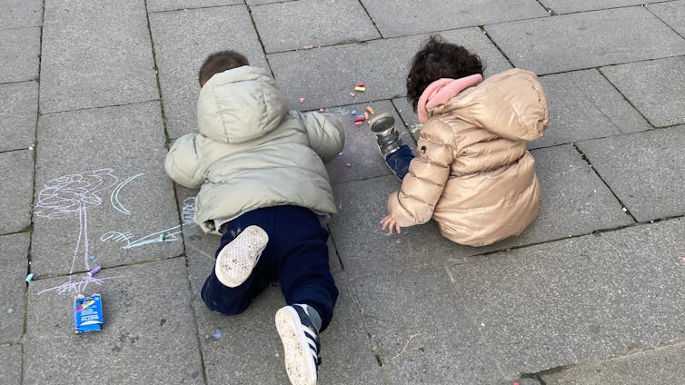 Children drawing on the pavement in Venice's San Giacomo dell Orio