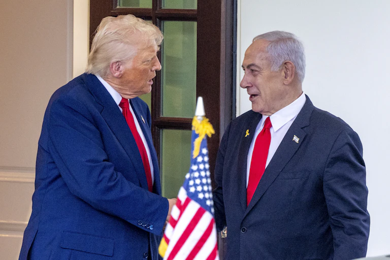 Donald Trump and Benjamin Netanyahu shake hands outside the White House.