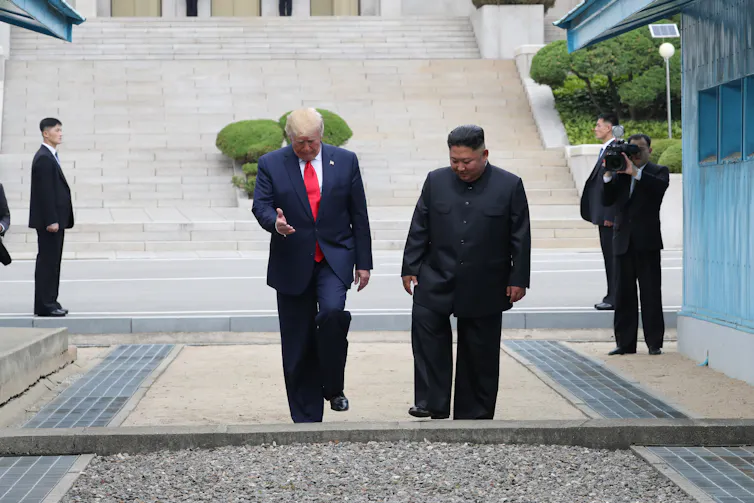 Trump walks with Kim Jong-un in the demilitarised zone separating the two Koreas.
