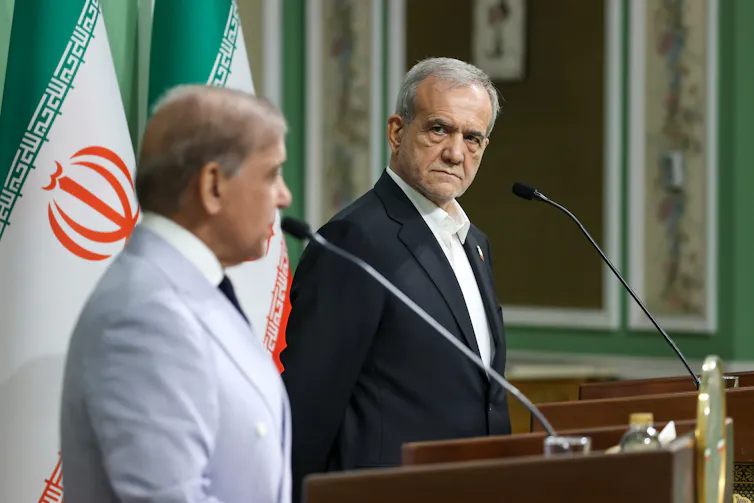 Masoud Pezeshkian stands alongside Pakistan's prime minister, Shehbaz Sharif, during a press conference.