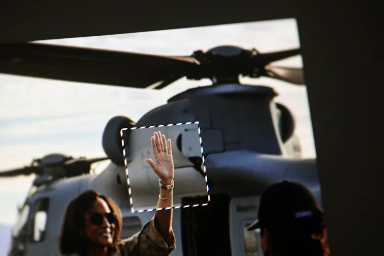 An AI-generated image shows a woman waving with a six-fingered hand.