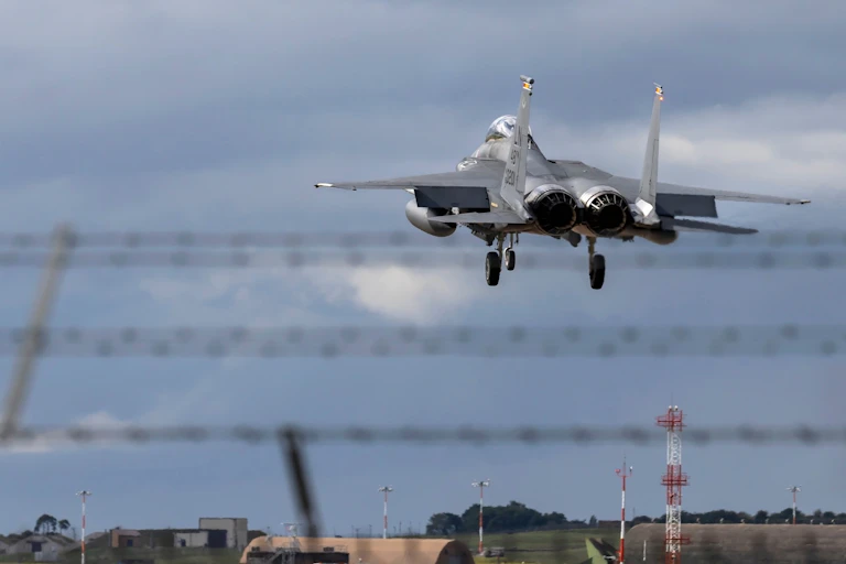 A fighter jet taking off from a military base.