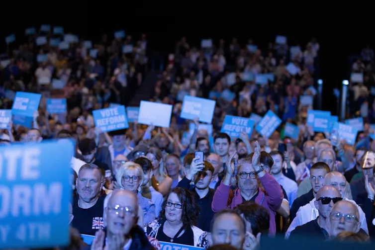 A crowd of Reform supporters, many holding blue signs that read Vote Reform July 4th