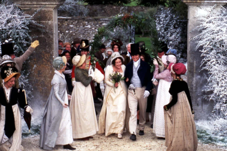 An early 19th-century wedding with women in bonnets and men in breeches and top hats.