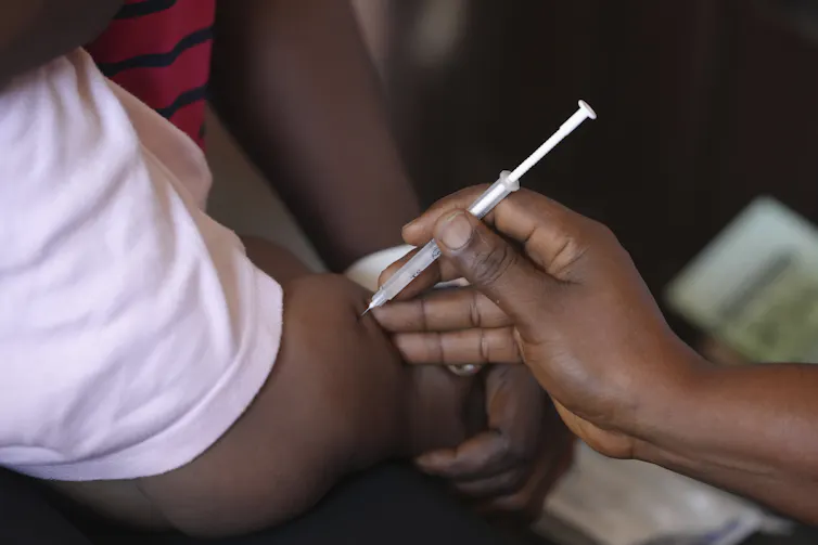 close up of a person getting a shot with a syringe