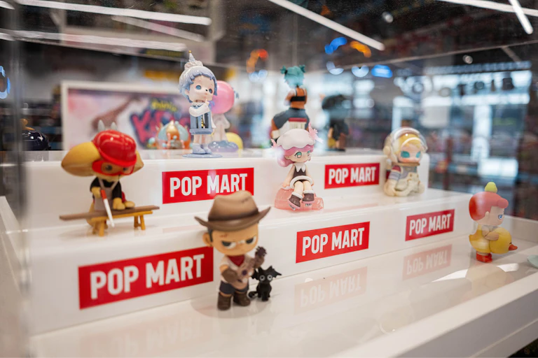 Collectible toy figurines on display, labelled with Pop Mart branding