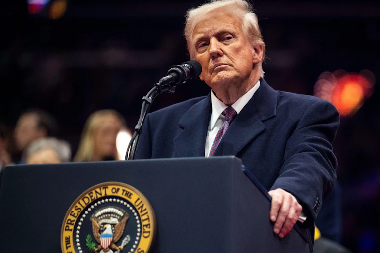 Donald Trump standing at a podium.