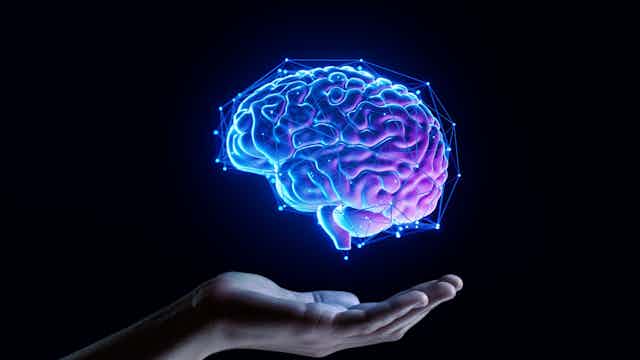 A hand holding a digital brain