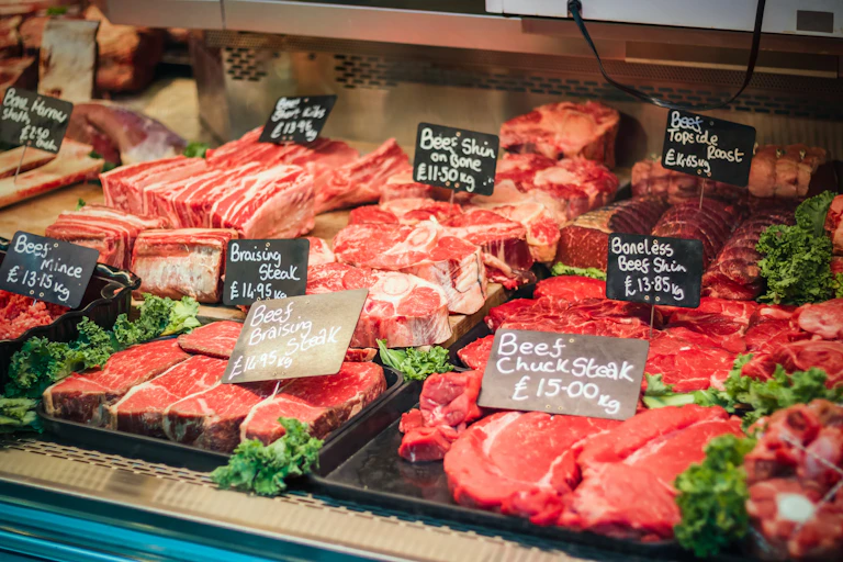 fresh beef laid out for sale in a uk butcher shop
