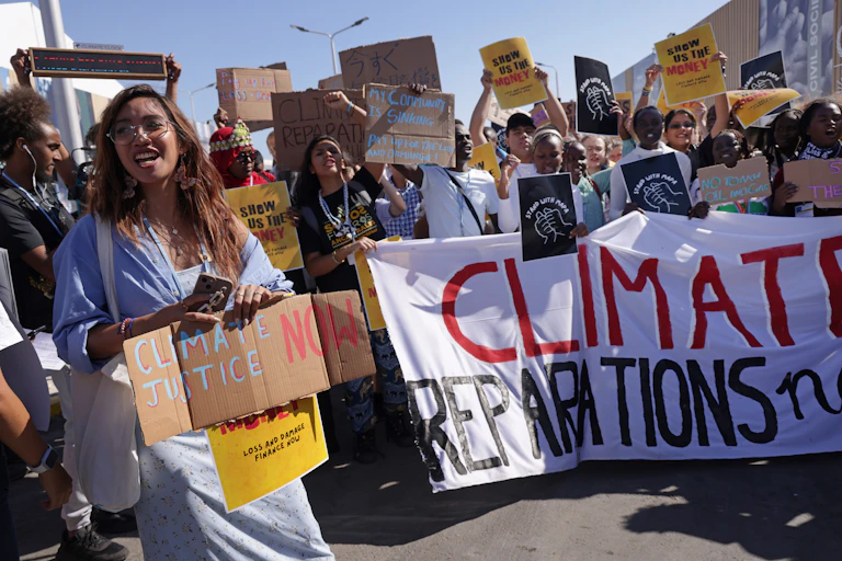 A group of people holding placards outdoors.