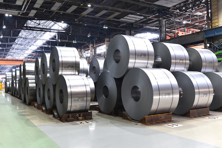 Large rolls of sheet steel in a warehous
