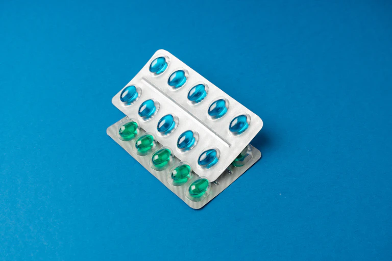 Two blister packs containing softgel capsules.